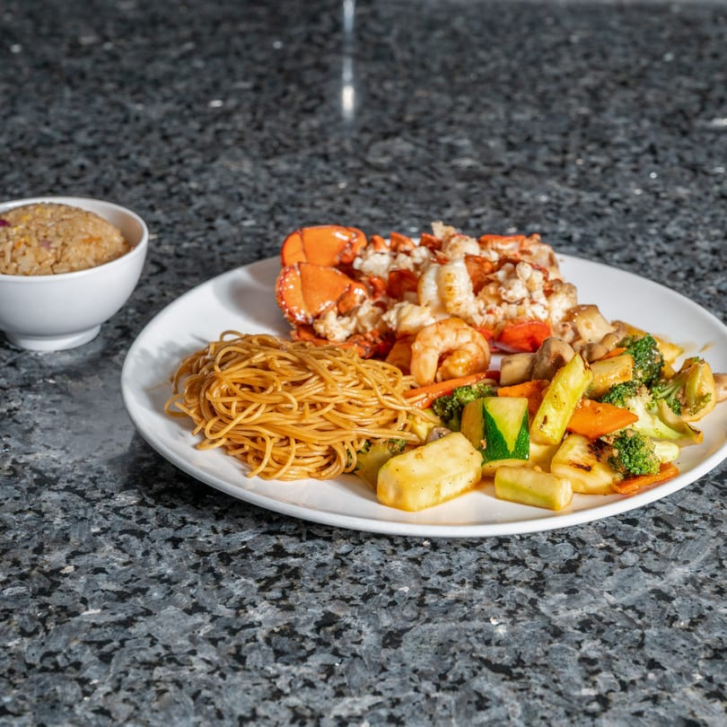Kabuki Japanese Cuisine's hibachi lobster, shrimp, noodles, and vegetables with a side of fried rice.