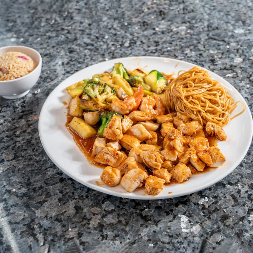 Kabuki Japanese Cuisine's chicken, shrimp, and vegetable stir-fry with noodles and a side of rice.
